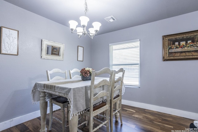 dining space featuring a chandelier, visible vents, dark wood finished floors, and baseboards