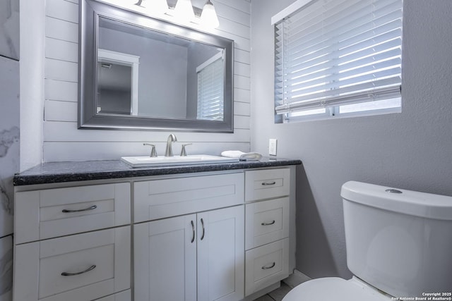 bathroom featuring toilet and vanity