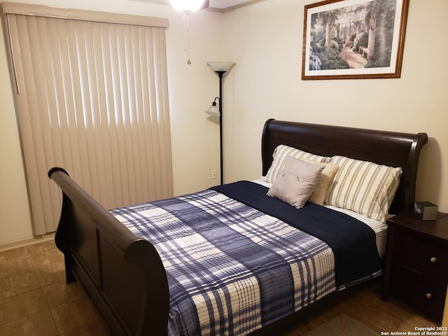 bedroom with dark tile patterned flooring