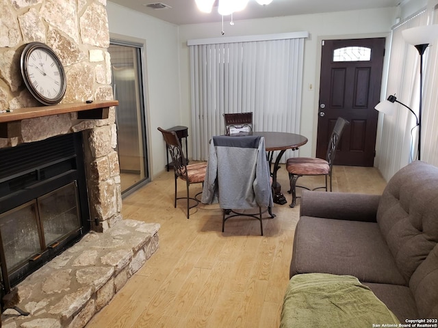 interior space with visible vents, a fireplace, and light wood-style flooring