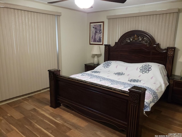 bedroom featuring dark wood-style floors and ceiling fan