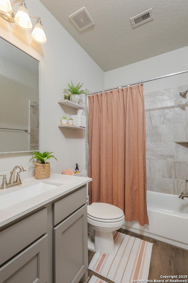 bathroom featuring shower / tub combo, visible vents, a textured ceiling, and vanity