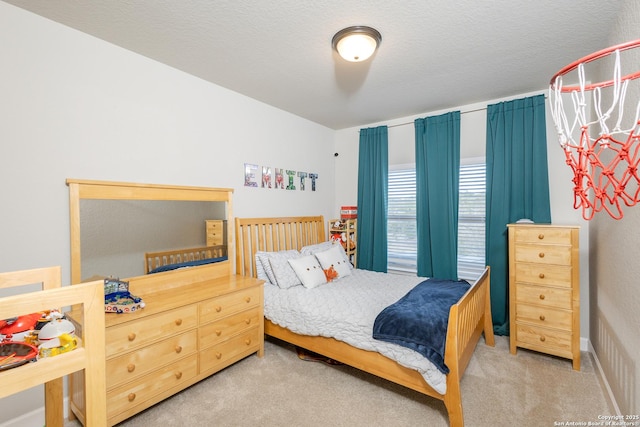 carpeted bedroom with a textured ceiling