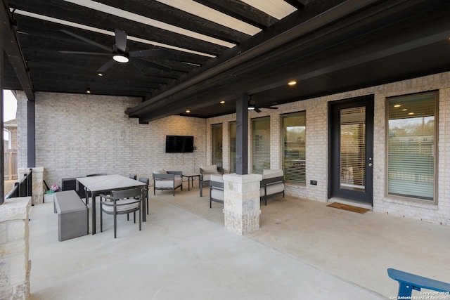 view of patio / terrace with an outdoor living space, a ceiling fan, and outdoor dining space