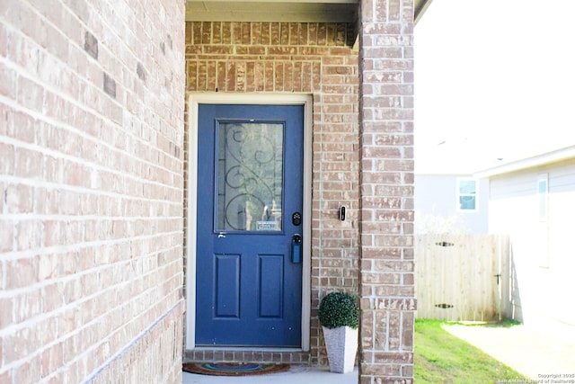 view of exterior entry with brick siding