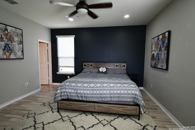 bedroom with a ceiling fan, baseboards, wood finished floors, and recessed lighting