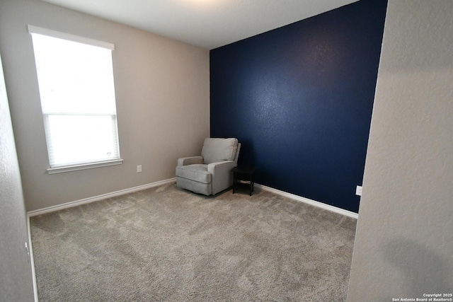 unfurnished room with light carpet and baseboards