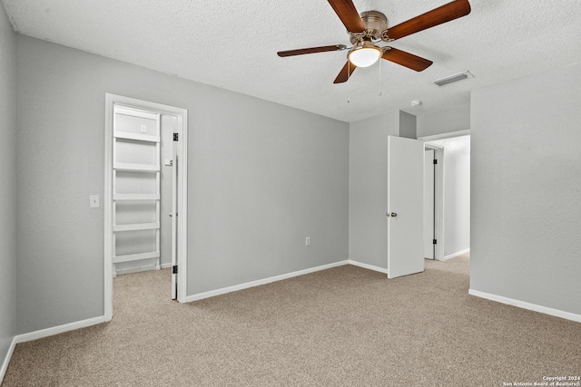 unfurnished bedroom with baseboards, visible vents, and light colored carpet