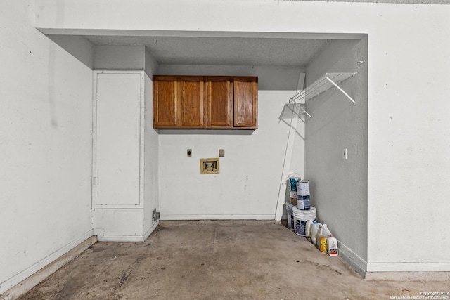 clothes washing area with hookup for a washing machine, cabinet space, electric dryer hookup, and baseboards