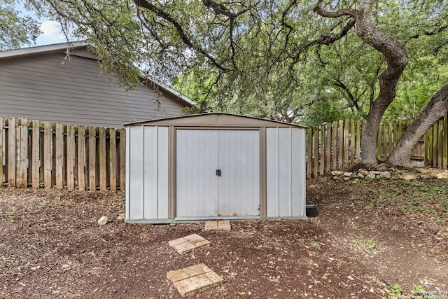 view of shed with a fenced backyard