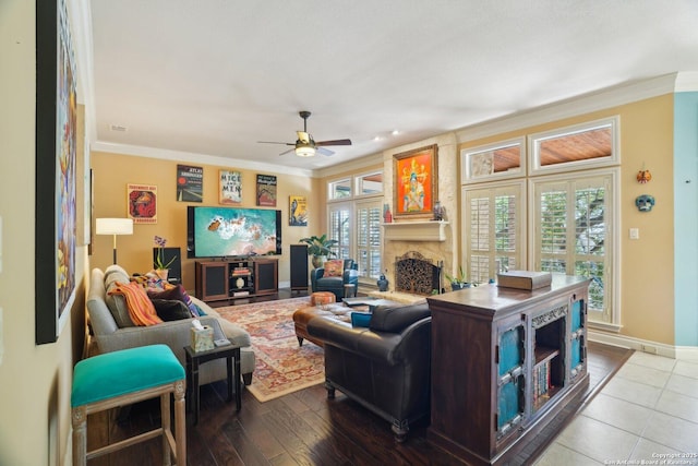 living room featuring ornamental molding, a fireplace, and baseboards