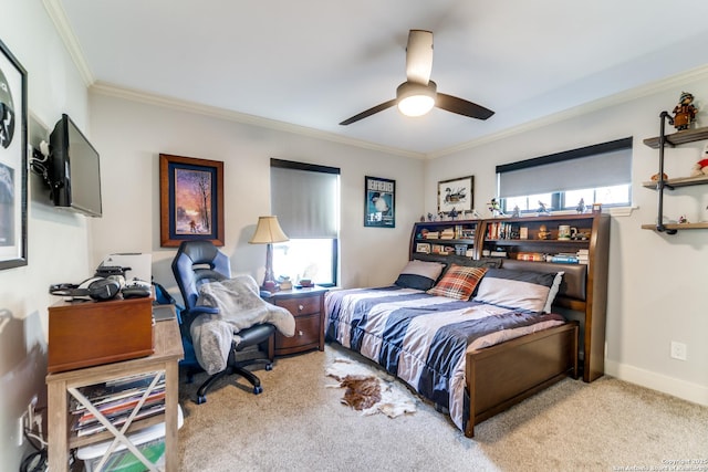 bedroom with ceiling fan, baseboards, crown molding, and light colored carpet