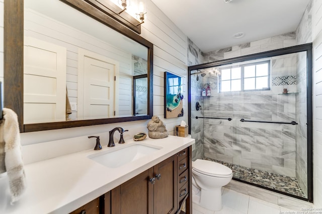 bathroom featuring a stall shower, vanity, and toilet