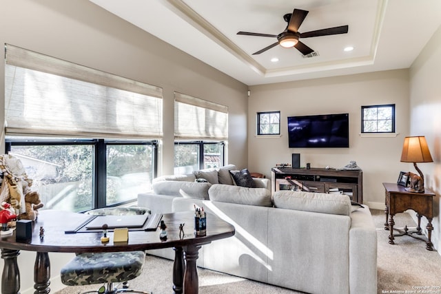 living room featuring baseboards, a raised ceiling, light colored carpet, ceiling fan, and recessed lighting