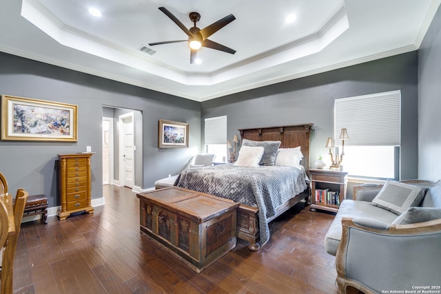 bedroom with dark wood-style floors, a raised ceiling, and visible vents