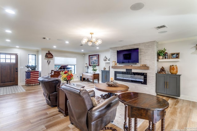 living room with light wood-style floors, a fireplace, and crown molding