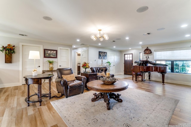 living room featuring light wood-style floors, visible vents, and ornamental molding