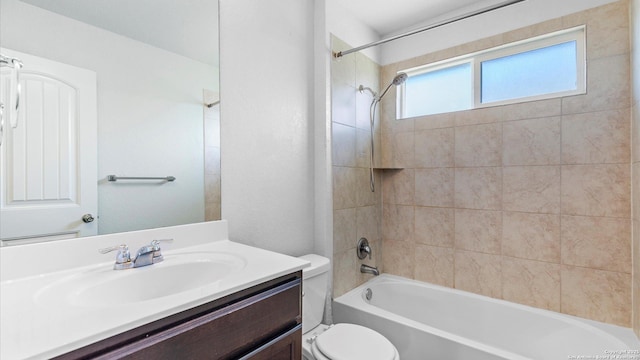 bathroom with toilet, vanity, and bathing tub / shower combination