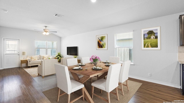 dining area featuring lofted ceiling, a ceiling fan, visible vents, and dark wood-style flooring