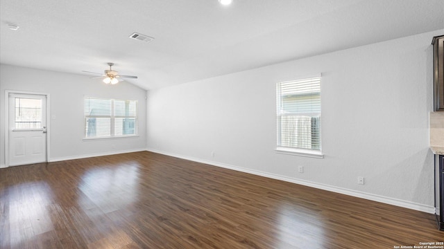 unfurnished living room featuring baseboards, visible vents, dark wood finished floors, a ceiling fan, and lofted ceiling