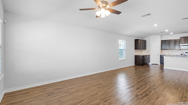 unfurnished living room featuring baseboards, visible vents, a ceiling fan, dark wood-style floors, and recessed lighting