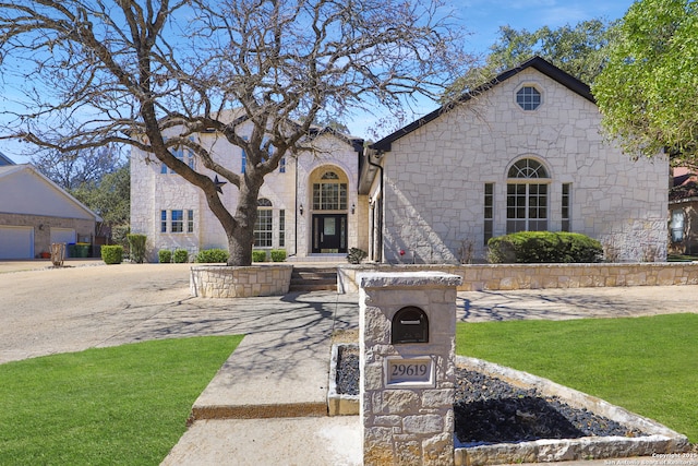 view of front of property with stone siding and a front yard