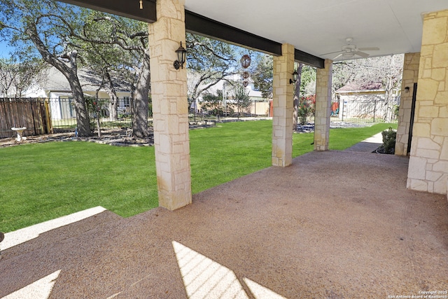 view of yard with ceiling fan, a patio area, and fence