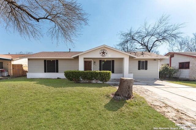 ranch-style home featuring concrete driveway, brick siding, a front yard, and fence