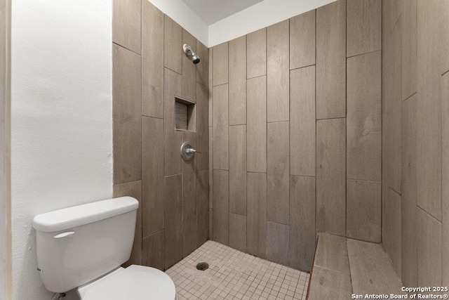 full bathroom featuring toilet and a shower stall