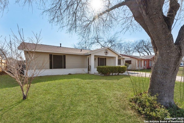 view of front of home with brick siding and a front lawn