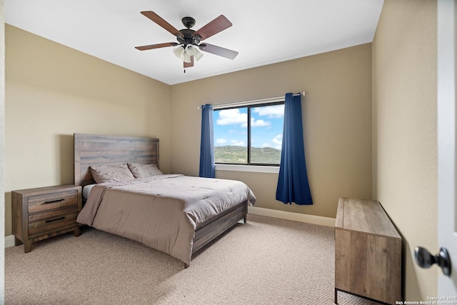 bedroom featuring baseboards, a ceiling fan, and light colored carpet