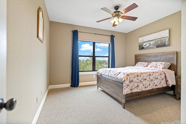 bedroom featuring light carpet, ceiling fan, and baseboards