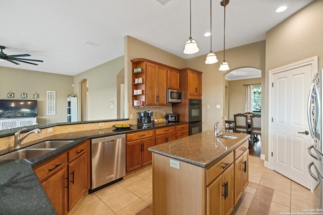 kitchen featuring appliances with stainless steel finishes, arched walkways, and a sink