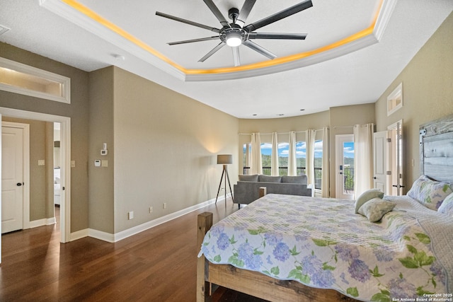 bedroom with dark wood-style flooring, a raised ceiling, visible vents, a ceiling fan, and baseboards