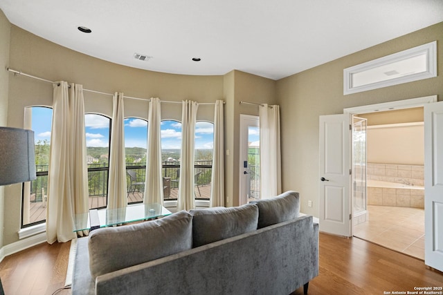 living room featuring visible vents and wood finished floors