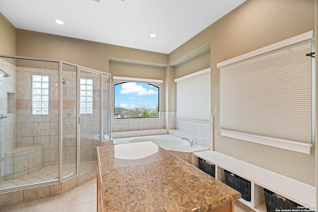 full bathroom with a wealth of natural light, a stall shower, tile patterned flooring, and a bath