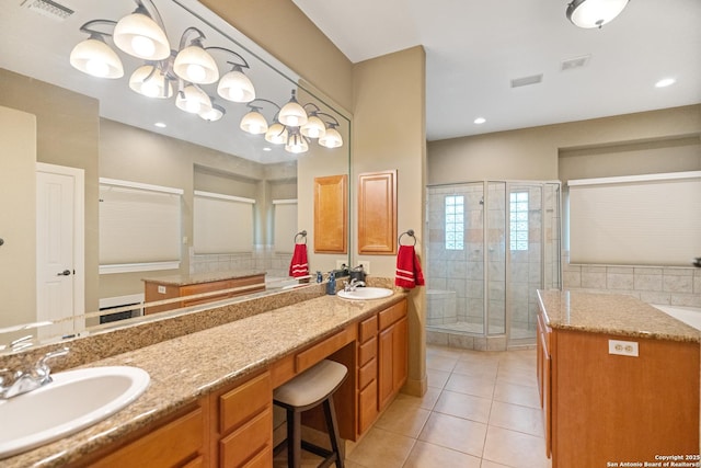 bathroom with double vanity, tile patterned flooring, a sink, and visible vents