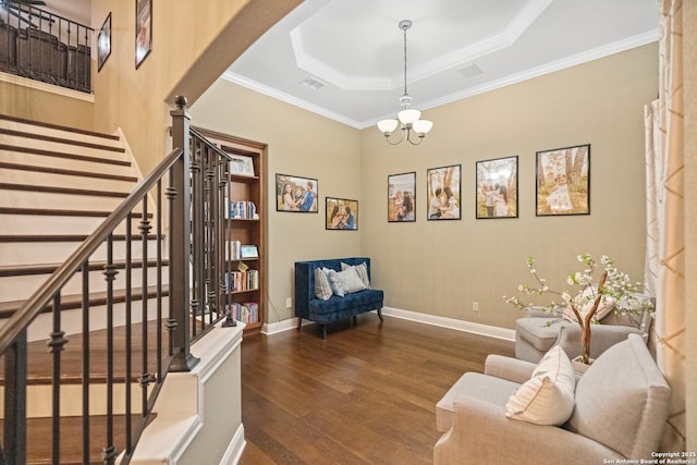 sitting room featuring dark wood-style floors, baseboards, stairway, and a raised ceiling