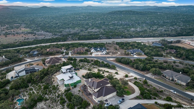 drone / aerial view featuring a residential view and a mountain view