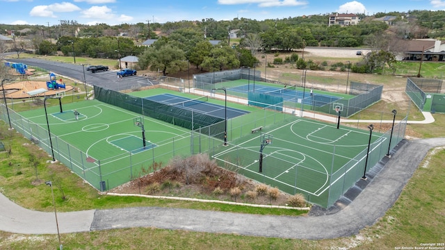 view of basketball court with community basketball court and fence