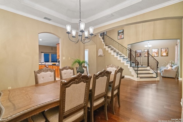 dining area featuring arched walkways, a notable chandelier, visible vents, dark wood-type flooring, and stairs