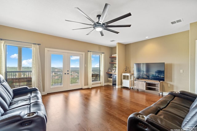 living room with baseboards, visible vents, ceiling fan, dark wood-type flooring, and french doors