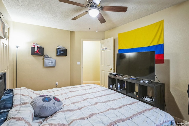 bedroom with a textured ceiling and a ceiling fan