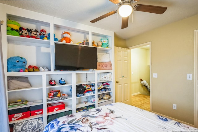 bedroom with ceiling fan and light wood-style flooring