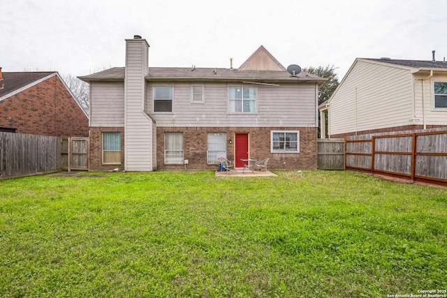 back of property featuring a fenced backyard, brick siding, a patio, and a lawn