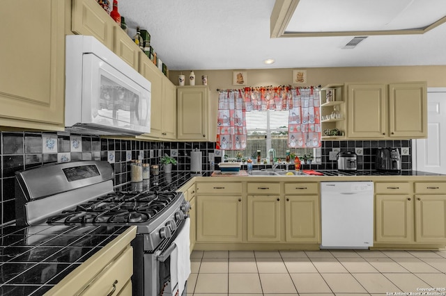 kitchen with white appliances, a sink, visible vents, tile counters, and open shelves