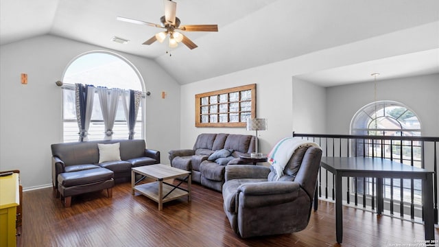 living room featuring a ceiling fan, vaulted ceiling, visible vents, and dark wood finished floors