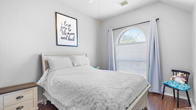 bedroom with a ceiling fan, dark wood-style flooring, visible vents, and baseboards