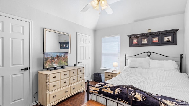 bedroom featuring lofted ceiling, ceiling fan, dark wood-style flooring, and baseboards