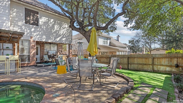 view of patio with outdoor dining area and fence